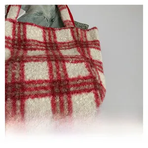 Macro view of red and white checkered plush fleece tote bag with detailed handle stitching