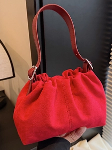 Minimalist red suede shoulder bag with pleated texture and silver buckle detail
