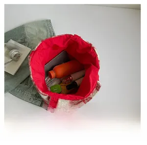 Top view of red and white checkered plush bucket bag showing large interior storage capacity