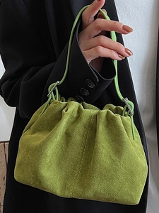 Vintage green suede pleated handbag with vertical stitching and cylindrical handles