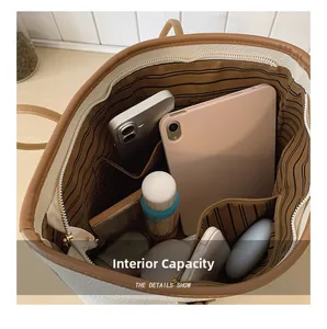 Top view of large white leather tote bag showing spacious striped interior and compartments