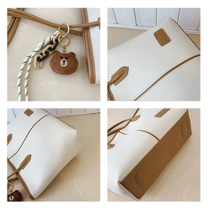 Detailed views of contrast-color tote bag featuring litchi grain and bear charm