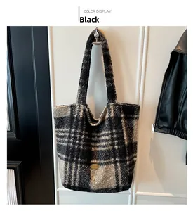 Detail of handmade gold metal tag on a black striped plush tote bag with tweed texture