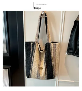 Close-up of beige and black striped plush tote bag with a small oval metal plate logo