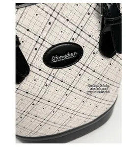 Detail of custom durable fabric bag with black lattice pattern and silver brand logo