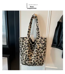 Detail showing plush black leopard print tote texture and silver metal nameplate