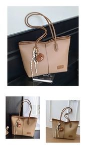 Close-up of khaki tote bag with litchi grain texture and a cute brown bear charm
