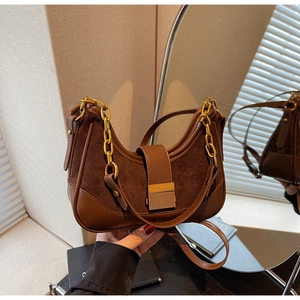 Detail of dark brown leather hobo bag featuring mixed suede textures and gold chain strap
