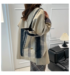 Detail of soft striped plush tote bag showing fuzzy faux fur texture and metal handmade tag
