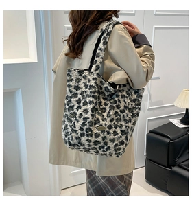 Detail of plush leopard print tote bag with metal tag and soft faux fur texture