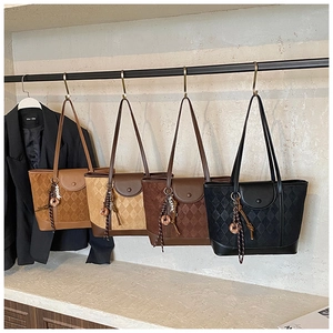 Detail showing four vintage tote bags with quilted patterns in various colors and textures