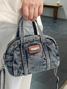 Distressed dark blue denim mini tote bag with brown leather accents and shoulder strap