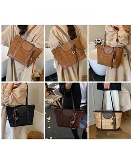 Detail view of large plaid tote bags in dark brown, black, and beige colors