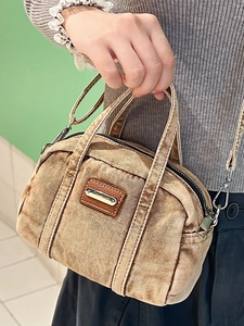 Vintage washed denim handbag in brown with adjustable shoulder strap and leather patch