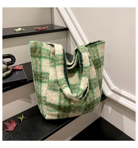 Close-up of a large-capacity plush tote bag featuring a green and brown checkered pattern