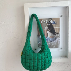 Detail of lime green quilted bubble hobo bag showing square puffy texture and fashion tag