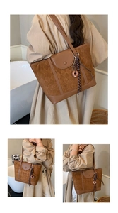 Detailed close-up of dark brown plaid tote bag featuring suede textures and stylish stitching