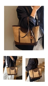 Detail view of khaki plaid tote bag featuring checkered pattern and decorative pendant