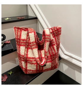 Detail of red and white checkered plush tote bag with autumn maple leaves on stairs