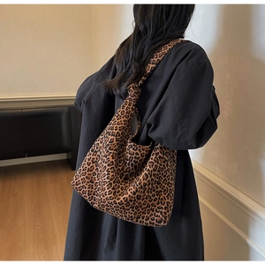 Detail of trendy leopard print tote bag featuring a creative knotted strap and soft fabric