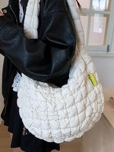 Minimalist white quilted cloud bag featuring yellow Fashion label and large capacity