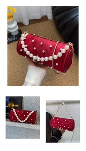 Detail of red velvet cylinder bag with pearl embellishments and golden chain strap