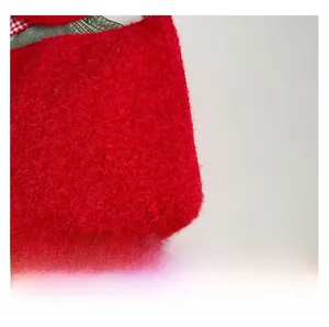 Macro shot of red plush faux fur texture with red and white plaid fabric splicing detail