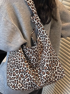 Chic leopard print canvas hobo tote bag for women featuring stylish knotted shoulder straps