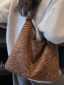 Brown zebra print canvas hobo bag with knotted strap for casual everyday shoulder wear