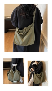 Detail of olive green canvas tote bag with adjustable straps and soft texture