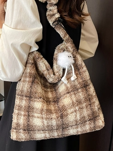 Brown and white checkered plush tote bag with a cute fuzzy doll charm worn crossbody