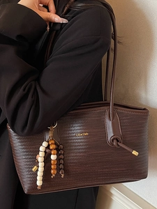 Brown woven texture tote bag with beads pendant and golden logo for minimalist daily style
