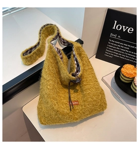 Detail of soft yellow faux fur texture and checkered lining on high-capacity hobo bag