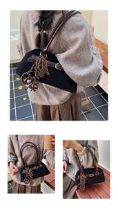 Detail of minimalist retro bowling bag with vintage charms and brown leather accents