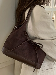 Brown suede tote bag for women featuring bow detail and minimalist design for commuting