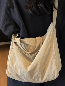 Minimalist beige oversized tote bag with dual handles and wide shoulder strap for commuting