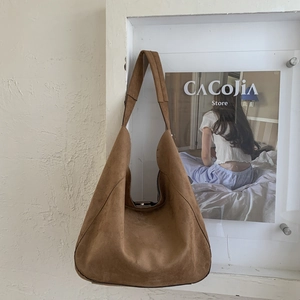 Macro shot of large brown suede tote bag texture and seamless wide shoulder strap