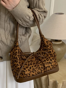 Stylish leopard print tote bag with brown leather handles and a bow for women