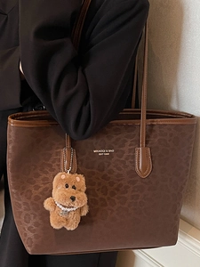 Brown leopard embossed large tote bag for women with a plush bear charm on a shoulder strap