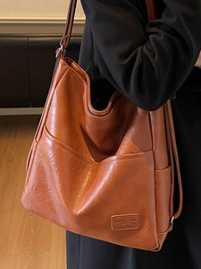 Caramel brown large capacity leather tote bag for women commuting with geometric pockets