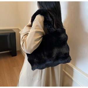 Vue détaillée du grand sac cabas en fausse fourrure noire montrant sa texture pelucheuse