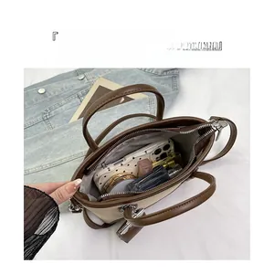 Top-down macro view of brown leather bucket bag interior showing organized storage space