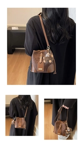 Detailed views of a brown textured bucket bag with shoulder strap and plush monkey charm
