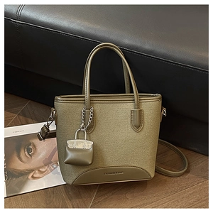 Detail of army green patchwork handbag with FASHION & BAG logo and leather textures