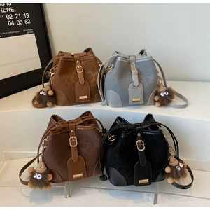 Detailed view of four textured bucket bags with leopard print finish and plush monster charms