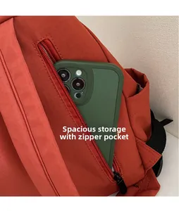 Detail of canvas backpack zipper pocket with a phone showing spacious storage