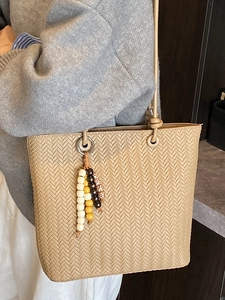 Chic woven beige tote bag with tassel beads and bohemian shoulder strap style