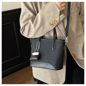 Fashionable black matte PU leather tote bag shown styled with a beige blazer outfit