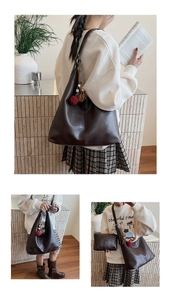 Detail view of large dark brown leather bucket bag with ball charms and matching small pouch