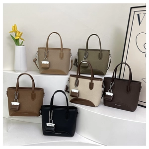 Close-up of minimalist fashion tote bags in six natural colors with metal chain charms